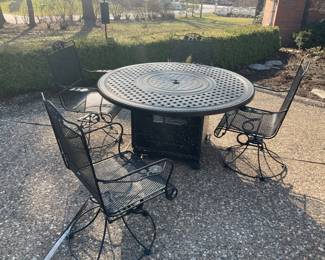 Table with gas pit, and four chairs the chairs are WOODARD. 