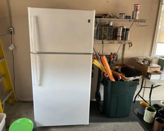 Nice refrigerator in the garage, ready to go move it out very easily