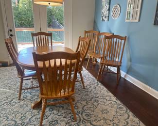 Oval table with two leaves built-in and seven chairs