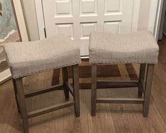Two upholstered counter-height stools.