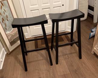 Two Pottery Barn Tibetan black bar-height stools