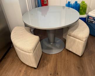 Children’s dry erase table with two storage benches on wheels.