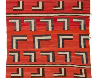 16
A Navajo banded textile
Early 20th century, Diné
Woven in red, cream, black, and dark brown wool, with bands of L-forms
75" H x 42" W
Estimate: $700 - $900