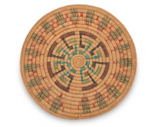 69
A large polychrome pictorial Navajo wedding basket
Late 20th century, Diné, atrributed to Kathy Bryant
A large coiled tray with central radiating hook motif and stylized stepped figural motifs to border
2.5" H x 21.5" Dia.
Estimate: $200 - $400
