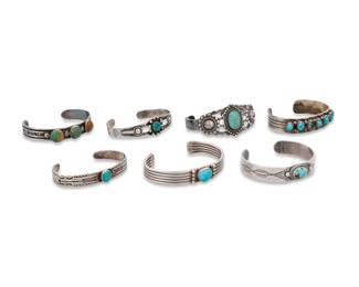 243
A group of Southwest style sterling silver and stone-set cuff bracelets
Mid/late 20th century
Four marked for sterling; two further marked for maker: Rs [possibly Rose Swett, Navajo/Diné] / Silver Arrow [company]
Comprising three stamped narrow cuffs with single set turquoise, a narrow five-wire cuff with set turquoise, a wider cuff with set turquoise and silver domes, as well as a narrow cuff with seven row-set turquoise stones, and an early stamped cuff with three row-set turquoise cabochons
7 pieces
Largest: 6.5" inner C x 1.125" H; Smallest: 6" inner C x 0.5" H
142.7 grams gross
Estimate: $500 - $700