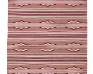 56
A Navajo Wide Ruins textile
Late 20th century, Diné, Dorothy Harvey
Woven in lavender, cranberry, mauve, cream, and grey/pink wool, with alternating bands of interrupted serrated diamonds
46.5" H x 32.5" W
Estimate: $300 - $500