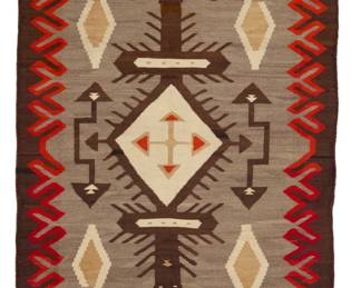20
A Navajo JB Moore Crystal rug
Early 20th century, Diné
Woven in red, cream, ochre, dark brown, and natural grey/brown wool, with elaborate diamonds within a half X-form border
106" H x 55" W
Estimate: $1,500 - $2,000