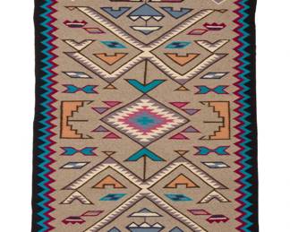 37
A Navajo Teec Nos Pos rug
Late 20th century, Diné, Mary White
Woven in grey, black, blue, cream, pink, purple, blue, and pale orange wool with a central serrated diamond flanked by two elaborate X-form motifs and a zigzag border
64" x 38" W
Estimate: $600 - $800