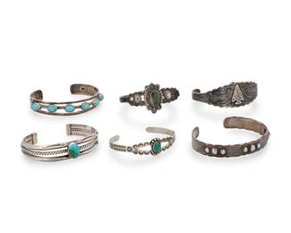 244
A group of Southwest style sterling silver and stone-set cuff bracelets
Mid/late 20th century
Four marked for sterling; one further marked for Mexico; MR / [Eagle 2]
Comprising three Fred Harvey-style cuffs, two with set stones, and each with stamp work, as well as a narrow stamped silver repoussé cuff with silver ball accents, a three-wire cuff with central set turquoise, and a three-wire Mexican silver cuff with row-set blue stones
6 pieces
Largest: 6.75" H x 0.5"" H; Smallest: 5.75" inner C x 0.5"H
100 grams gross
Estimate: $200 - $400