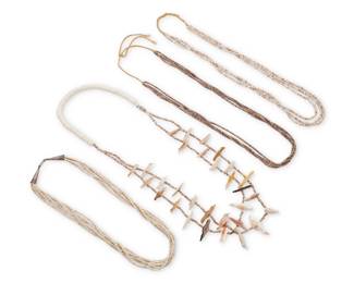 224
A group of Southwest Pueblo heishi and carved shell necklaces
Mid/late 20th century
Comprising a two-strand fetish necklace with carved shell and mother-of-pearl birds and heishi spacers (30" L), a triple strand necklace of clam shell heishi (26" L), a four-strand necklace with olive shell heishi (28" L), and a six-strand clam shell heishi necklace with silver cone clasp (22" L), two with a traditional wrapped neck cord
4 pieces
175.7 grams gross
Estimate: $500 - $700