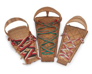 146
A group of Mono basketry cradleboards
Mid-20th century; Central California
Three twined cradleboards each with integral shaped hoods of varying sizes, and each with striped and diagonal banding and ticking style patterns, including a large board with painted dot motifs and green, orange, and black woven binding strap, one with red, white, and blue woven binding strap, and one with a narrow hood and black, red, and white bindings
3 pieces
Largest: 32"H x 15.75" W x 8.5" D; Smallest: 25" H x 10.5" W x 9" D
Estimate: $600 - $900