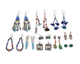 257
A group of Southwest style earrings
Mid/late 20th century
Ten pairs of earrings in various styles and materials such as silver cones, heishi beads, trade beads, with various stones such as lapis lazuli, turquoise and coral, and in various styles including a pair of heishi and trade bead 'grandmother'-style earrings, an early tab turquoise and coral dangle pair, and a set turquoise stud pair, a carved blue stone bear fetish pair and a pair of multicolored beaded corn husk earrings, a black and white ceramic pictorial Southwest cat pair, and a pair of oval silver overlay earrings
20 pieces
Largest: 4" H; Smallest: 0.5" Dia.
84.2 grams gross
Estimate: $200 - $400