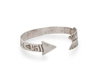 191
A Southwest sterling silver 'Arrow' cuff bracelet
Early/mid-20th century
Unmarked
An early narrow cuff with point and feather shaped terminals and stamp work including whirling logs and other geometric motifs
7" total inner C x 0.625" H
19.0 grams gross
Estimate: $200 - $400
