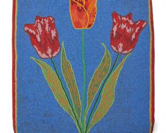 172
A Nez Perce/Plateau floral beaded bag
Mid-20th century
A rectangular bag with tulip motif on front panel in multicolored beads of red, orange, and yellow on a vivid blue field, edged with red fabric, the back of the bag in a swirled red brocade, the interior lined with lilac fabric, and with hide laces to top
112.5" H x 11.5" W
Estimate: $200 - $300