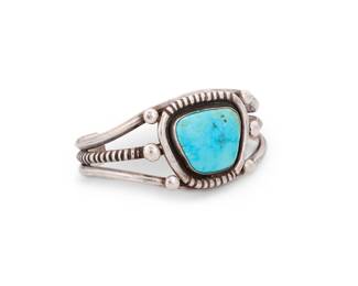 195
A Southwest sterling silver cuff bracelet
Mid/late 20th century
Unmarked
A three-wire cuff with incised central wire and shaped central set trapezoid turquoise with incised edging and silver ball accents
6.5" total inner C x 1.375 " H, with a 1.25" gap
58.3 grams gross
Estimate: $300 - $500