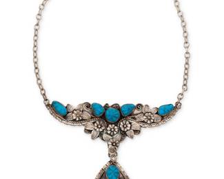 199
A Jerry Roan Navajo silver and turquoise necklace
Jerry Roan (b. 20th century, Diné)
Late 20th century
Stamped: JR [conjoined]
An ornate plaque necklace with carved set turquoise amidst elaborate silver overlay floral accents, suspending a teardrop silver and turquoise pendant
14" L x 4.25" H x 5" W
67.6 grams gross
Estimate: $600 - $800