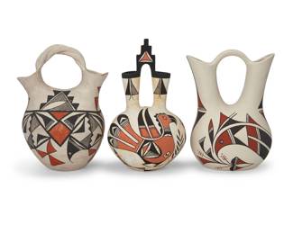 113
Three Acoma Pueblo polychrome pottery wedding vases
Mid-20th-early 21st century
One marked: Acoma Sky City; another: AR / Pueblo of Acoma; the last: "Parrot" Wedding vase W/B ©
Each three-color vase with orange and brown/black avian and geometric motifs on a cream slip ground, one with a twisted handle and another with a kiva-form handle
3 pieces
Kiva/parrot: 8.875" H x 5.25" Dia.; Shortest: 8" H x 5.5" W x 4.75" D
Estimate: $300 - $500