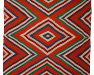 24
A Navajo Germantown eye dazzler blanket
Late 19th/early 20th century, Diné
Woven in Germantown wool of dark and mid-red, green, blue, and cream wool, with three conjoined serrated diamonds
83" H x 57.5" W
Estimate: $1,000 - $1,500