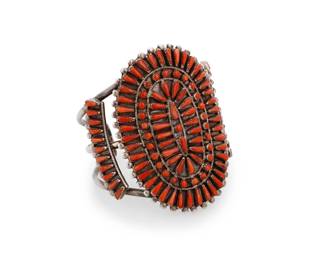 107
A Vernon Wallace Zuni petit point coral cuff bracelet
Vernon Wallace (b. 1950, Zuni Pueblo)
Late 20th century
Etched verso: V. Wallace
A sterling silver three-wire cuff with a large petit point coral cluster-set plaque and row-set shoulders
6.25" total inner C x 2.75" H, with a 0.75" gap
50.8 grams gross
Estimate: $600 - $800
