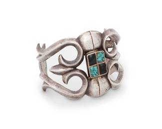 88
A Southwest silver sandcast and turquoise cuff bracelet
Mid-20th century
Unmarked
A chunky openwork curvilinear cuff with central set turquoise and onyx and with shaped terminals
7" total inner C x 2.125" H, with a 1.625" gap
94.2 grams gross
Estimate: $400 - $600