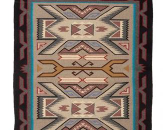 36
A Navajo Teec Nos Pos textile
Late 20th century, Diné; attributed to Gloria Nelson
Woven in grey, black, tan, red, blue, and cream wool depicting central waterbug motif and elaborate X-form waterbugs on either side, within an elaborate border, with a'ch'ihónít'i' or spirit line extending from one corner
47" H x 40.5" W
Estimate: $500 - $700