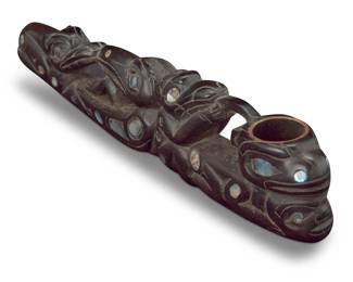 135
Rich Lavalle (adopted Tlingit, b. 1945)
A carved wood and inset abalone shell pipe, circa 1970s
Incised signature: LAVALLE
Carved with various figures and fitted with a metal pipe bowl insert
8" L x 1.875" W x 1" D
Estimate: $700 - $900