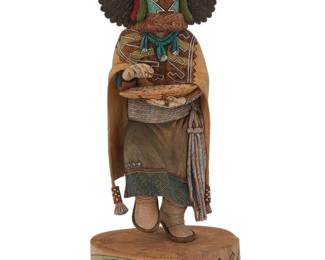176
Kerry David (b. 1963, Hopi-Tewa/Navajo)
A polychrome carved cottonwood eagle dancer katsina, late 20th/early 21st century
Signed to underside: Carved by Kerry L. David ©
Depicted with a fox pelt and woven basket, raised on a base incised and painted with a kiva and tawa mask
Figure: 9.5" H x 3.75" W x 3" D; Overall: 11.25" H x 5.125" W x 4.125" D
Estimate: $300 - $500