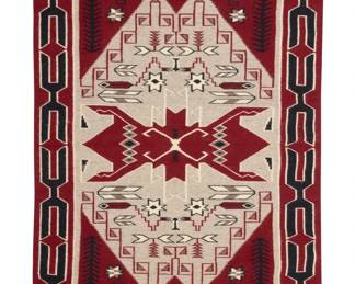 39
A Navajo Teec Nos Pos rug
Late 20th century, Diné, Alice Yazzie (1923-2024)
Woven in dark red, black, natural brown, natural grey, and cream wool, with corn stalks, feather motifs, and multiple geometric and pictorial elements within an x-form border
59" H x 37.25" W
Estimate: $600 - $900