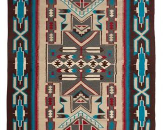 34
A Navajo Teec Nos Pos rug
Late 20th century, Diné, Rose Nargo
Woven in brown, black, red, turquoise, natural grey, and cream wool, with feather motifs and stacked diamonds within a stepped x-form border
85.5" H x 53.5" W
Estimate: $1,000 - $1,500