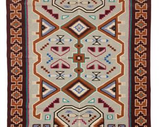 35
A Navajo Teec Nos Pos rug
Late 20th century, Diné, Hazel Tom Taylor
Woven in multicolor wool, with feather motifs, serrated diamonds, and geometric motifs within a stepped x-form border
76" H x 55.5" W
Estimate: $800 - $1,200