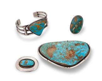 218
A group of Southwest sterling silver and turquoise set jewelry
Mid/late 20th century
Buckle etched with owner's initials: JLT; brooch marked: Rivera's [likely Arturo Rivera]
Comprising a chunky three-wire cuff with a large set slab turquoise stone, as well as a large slab turquoise belt buckle, a Rivera's shadowbox set turquoise oval brooch, and a large oval set turquoise ring
4 pieces
Buckle: 2.625" H x 4.125" W; Cuff: 7" total inner C x 1.625" H; Brooch: 1.375" H x 1.75" W ; Ring: size: 8.5
224.3 grams gross
Estimate: $700 - $900