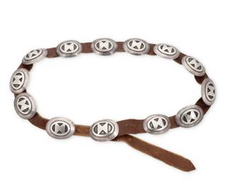 91
A Navajo sterling silver concho belt
Mid-20th century, Diné
Unmarked
Comprising twelve oval conchos and matching buckle, each with a silver overlay butterfly motif, and all mounted to a leather belt strap
Buckle: 1.625" H x 2" W; Each concho: 1.5" H x 1.875" W; Belt: 36.5" L x 0.75" H
197.7 grams gross
Estimate: $500 - $700