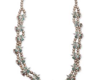 170
A Charlie Singer Navajo silver 'Peyote Bird' squash blossom necklace
Charlie Singer (1931-2018, Diné)
Late 20th/21st century
Stamped with arrowhead picto mark for Charlie Singer
A double strand squash blossom-style necklace with fourteen turquoise and coral mosaic chip inlay "anhinga" or peyote bird "blossoms" and a central peyote bird naja
32" L x 2" H
115.5 grams gross
Estimate: $500 - $700