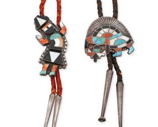 219
Two Zuni Pueblo style inlaid stone bolo ties
Mid-20th century
Each unmarked
Comprising two Rainbow Guardian figural bolos in silver and stone inlay including turquoise, spiny oyster, mother-of-pearl, and coral, each on a braided leather cord with silver tips
Largest bolo: 2.75" H; smallest: 2" H; each cord: 36" L approximately
72.3 grams gross
Estimate: $300 - $500