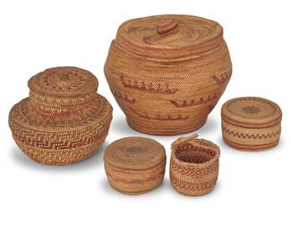 136
A group of polychrome Northwest Coast baskets
Early/mid-20th century; Pacific Northwest
Comprising a tall lidded twined basket with multiple sawtooth canoe motifs and striped banding, with swirl motifs to lid (8" H x 9" Dia.), a smaller lidded twined basket with multicolored stepped and sawtooth banding (6" H x 6.5" Dia.), as well as two small lidded finely twined round baskets, each with multicolored striped and geometric banding (2.25" H x 4" Dia. & 2" H x 3.5" Dia.), and a diminutive small twined basket with long handle and herringbone bands (2.5" H x 3" Dia.)
5 pieces
Estimate: $300 - $500