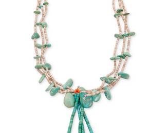 120
A Kewa Santo Domingo Pueblo turquoise and heishi shell necklace
Early/mid-20th century, Santo Domingo Pueblo
Comprising three strands of shell heishi with graduated turquoise tabs suspending a pair of attached jaclas in rolled turquoise, coral, and clam shell
30" L x 5.5" H
159.5 grams gross
Estimate: $400 - $600