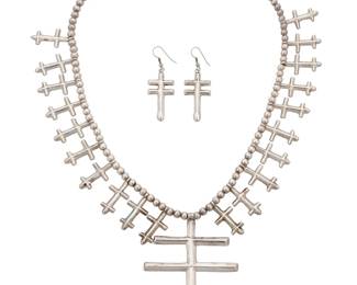 158
An Isleta Pueblo cross necklace and earrings
Late 20th/early 21st century
Stamped with double-struck 'A' with a long foot for either Anthony Lovato or Ambrose Lincoln; further stamped: Sterling
A single strand of silver beads supporting twenty tufa-cast crosses and finished with a large tufa-cast cross pendant, with a pair of unmarked cast cross earrings
3 pieces
Necklace: 24.25" L x 4" H; earrings: 1.75" H x 0.875" W
140.4 grams gross
Estimate: $800 - $1,200