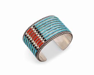 109
A Jimmie King Jr Navajo sterling silver and stone inlay cuff bracelet
Jimmie King Jr. (d. 2017; Diné)
Late 20th/early 21st century
Stamped: JR [conjoined] [six dots] / Sterling
A wide chunky sterling silver cuff with bands of turquoise, coral, and mother-of-pearl sculptural inlay
6.5" total inner C x 1.625" H, with a 1.125" gap
143.2 grams gross
Estimate: $1,000 - $1,500