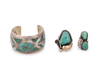 258
A group of Southwest style sterling silver, 14k gold, and turquoise jewelry
Mid/late 20th century
Each unmarked
Comprising wide chunky sterling silver cuff with a central set turquoise stone and turquoise chip mosaic inlay to band, together with two sterling silver and set turquoise rings, one with applied 14k gold leaf motif
3 pieces
Cuff: 7.25" total inner C x 1.625" W, with a 1.375" gap; rings: sizes 8 & 7
129.5 grams gross
Estimate: $400 - $600