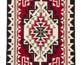 42
A Navajo Ganado rug
Late 20th century, Diné, Vangie Wright
Woven in red, black, cream, and natural grey wool, with an elaborate central stepped diamond within a stepped border, with red spirit line
66" H x 36" W
Estimate: $400 - $600