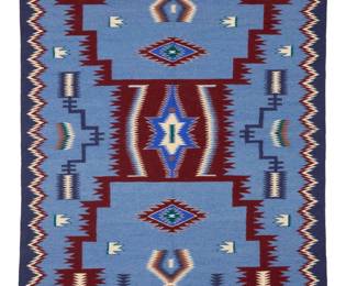 52
A Navajo Storm Pattern rug
Late 20th century, Diné, attributed to Minnie Conn
Woven in dark blue, pale blue, royal blue, red, cream, green, and ochre wool, with a central storm pattern, serrated diamonds, and a serrated border
61" H x 45" W
Estimate: $700 - $900