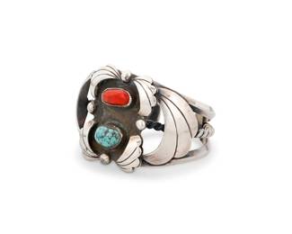 190
An Alfred Joe Navajo sterling silver and set stone cuff bracelet
Alfred Joe (b. 1950, Diné)
Late 20th/21st century
Stamped: AJ [conjoined]
A chunky three-wire cuff with central plaque set with coral and turquoise, with stylized silver overlay feathers to each side
6" inner C x 1.75" H, with a 0.75" gap
62.4 grams gross
Estimate: $300 - $500