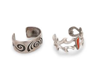 265
Two Southwest silver cuff bracelets
Mid/late 20th century
One marked: Hc [conjoined, for Hopi Enterprises/Hopi Crafts]
Two works comprising a chunky silver overlay cuff with textured concentric curvilinear motifs to center and arabesque motifs to terminals (6.25" total inner C x 1" H, with a 1.125" gap) as well as a cast silver openwork cuff with central set coral (6.125" total inner C x 1.25" H, with a 1.125" gap)
2 pieces
100.9 grams gross
Estimate: $600 - $800
