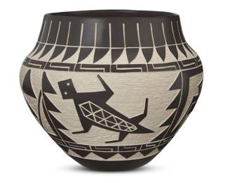 96
A Laguna Pueblo sgraffito pottery olla
Late 20th century
Incised to underside: PL / Laguna
Likely Paul Lucario, Jr. (b. 20th century, Laguna Pueblo), the black slip layer carved to depict a band of feathers to rim and turtle fetishes to body, in-filled with white slip
7.875" H x 9.5" Dia.
Estimate: $200 - $400