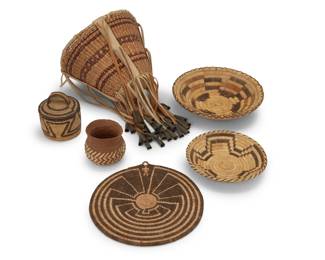 232
A group of Southwest baskets
Mid-20th century
Six baskets comprising an Apache-style twined burden basket with striped banding hide leather strapping and fringe with tin dangles (7.5" H x 9.75" H), four Tohono O'odham (Papago) baskets including two coiled low basketry trays with geometric cross motifs (2" H x 9.5" Dia. & 1.5" H x 7" Dia.), and a small 'Man in a Maze' basketry plaque (9.5" Dia.), as well as a small coiled lidded basket with zigzag meander motif and curved handle (4.25" H x 3.75" Dia.), and a small woven Mexican Tarahumara olla basket with herringbone patterns (3.5" H x 3.75" Dia.
6 pieces
Estimate: $200 - $400