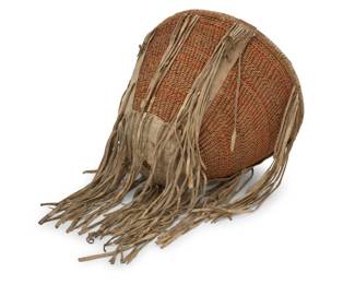 154
An Apache burden basket
Early 20th century; Southwest United States
A twined tapered tall basket featuring hide strapping to rim and sides and hide reinforcement to underside, adorned with hide fringe, and with added orange pigment banding
10" H x 13.75" Dia.; Fringe: 10" L approximately
Estimate: $400 - $600