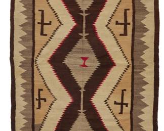 8
A Navajo regional rug
Early 20th century, Diné
Woven in red, cream, light and mid-grey, tan, and dark brown wool, with stacked serrated diamonds and floating whirling logs
78" H x 54" W
Estimate: $600 - $800