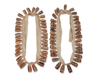 220
A pair of Hopi Pueblo olive shell bandoliers
Mid-20th century, Southwest United States
Two ceremonial dance bandolier ties each suspending multiple graduated whole shells stitched to cotton twill tape straps
Each: 61" L x 3.5" H approximately
Estimate: $200 - $400