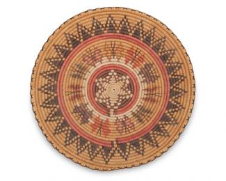 70
A polychrome pictorial San Juan Paiute butterfly basket
Late 20th century; Southwest United States, attributed to Grace Lehi
A small coiled tray, in wedding basket-style, with a central star surrounded by a band of multiple butterfly motifs and and outer stepped sawtooth sunburst band and herringbone stitch rim
2" H x 13" Dia.
Estimate: $300 - $500
