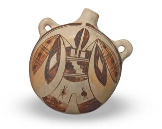 100
A Hopi Pueblo pottery canteen
Late 19th/early 20th century, possibly Nampeyo of Hano (Hopi-Tewa, 1857-1942)
The three-color canteen with orange and brown winged figure to one side on a cream slip ground
5.125" H x 4.875" W x 2.875" D
Estimate: $500 - $700